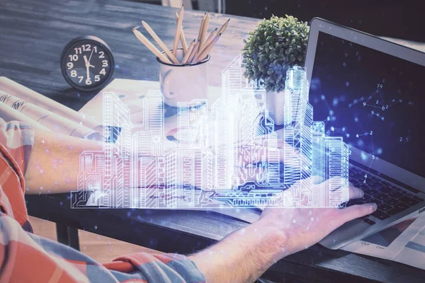 High tech city drawing with businessman working on computer on background. Smartcity concept. Double exposure.