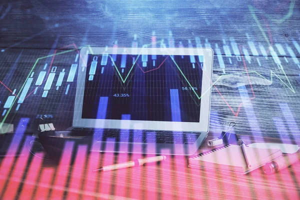 Financial market graph hologram and personal computer on background. Multi exposure. Concept of forex.