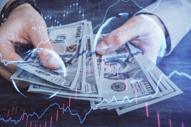 Finansal grafiğe çoklu pozlama hologram, Amerikan dolarları ve insan eli. Analiz kavramı.
