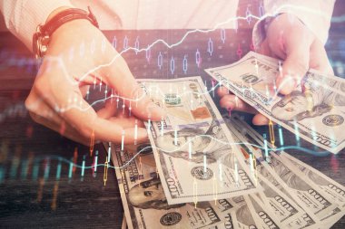 Finansal grafiğe çoklu pozlama hologram, Amerikan dolarları ve insan eli. Analiz kavramı.