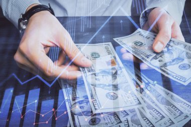 Finansal grafiğe çoklu pozlama hologram, Amerikan dolarları ve insan eli. Analiz kavramı.