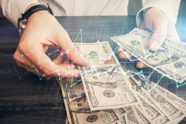 Finansal grafiğe çoklu pozlama hologram, Amerikan dolarları ve insan eli. Analiz kavramı.
