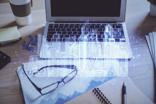 Desktop computer background in office and big town buildings hologram drawing. Double exposure. Smart city concept. — Stock Photo, Image