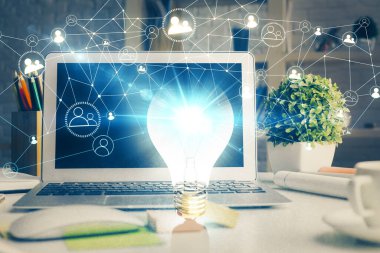 Bilgisayar ofisinde ampul simgesi hologramıyla birlikte. Çifte maruziyet. Fikir kavramı.