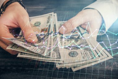 Finansal grafiğe çoklu pozlama hologram, Amerikan dolarları ve insan eli. Analiz kavramı.
