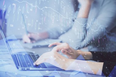 Bilgisayarda ve finansal grafik hologramında yazı yazan kadın ellerine çok maruz kalmış. Borsa analizi kavramı.