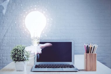 Bilgisayar ofisinde ampul simgesi hologramıyla birlikte. Çifte maruziyet. Fikir kavramı.
