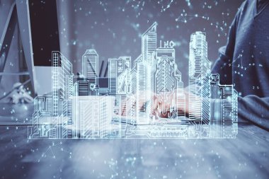 Arka planda bilgisayar üzerinde çalışan bir iş adamı ile yüksek teknoloji şehir çizimi. Akıllılık konsepti. Çift pozlama.