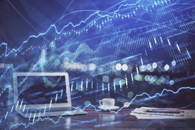 Finansal pazar grafiği hologramı ve kişisel bilgisayar arka planda. Çoklu maruz kalma. Önx kavramı.