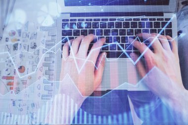 Dizüstü bilgisayar klavyesini ve ön x çizim hologramını yazarken çift pozlama. Üst Manzara. Finans piyasası kavramı.