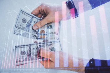 Finansal grafiğe çoklu pozlama hologram, Amerikan dolarları ve insan eli. Analiz kavramı.