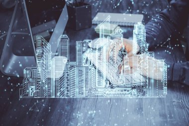 Arka planda bilgisayar üzerinde çalışan bir iş adamı ile yüksek teknoloji şehir çizimi. Akıllılık konsepti. Çift pozlama.