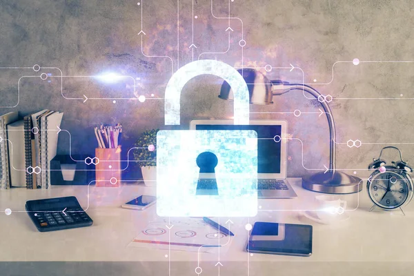 Double exposure of desktop with computer and lock icon hologram. Concept of data safety.