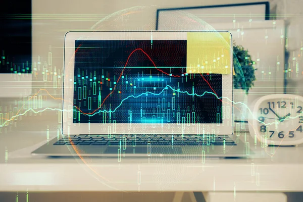 Double exposure of graph and financial info and work space with computer background. Concept of international online trading.