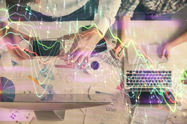 Double exposure of man and woman working together and financial chart hologram drawing. market analysis concept. Computer background. Top View.