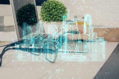 Arka planda bilgisayar üzerinde çalışan bir iş adamı ile yüksek teknoloji şehir çizimi. Akıllılık konsepti. Çift pozlama.