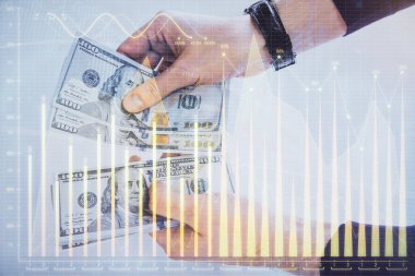 Finansal grafiğe çoklu pozlama hologram, Amerikan dolarları ve insan eli. Analiz kavramı.