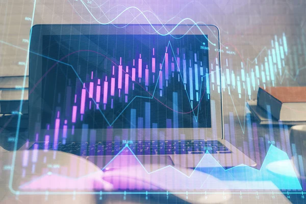 Forex market graph hologram and personal computer on background. Multi exposure. Concept of investment.