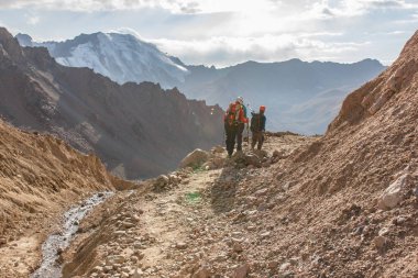 Maceracı adam dağın tepesinde duran ve canlı bir gün batımı sırasında güzel manzarayı