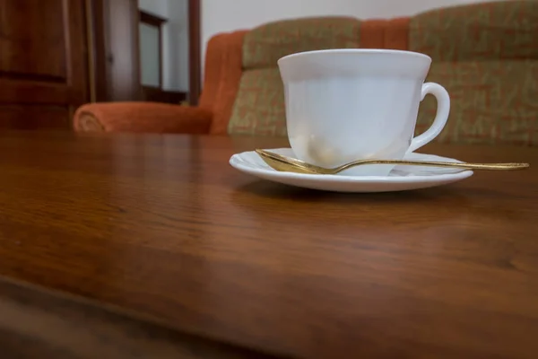 White Mug Saucer Spoon Standing Wooden Table Sofa — Stock Photo, Image