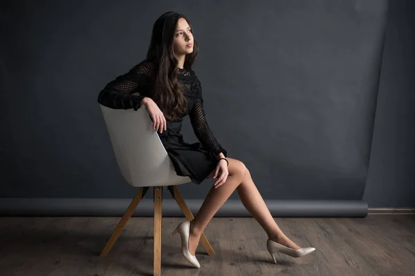 Young Pretty Sweet Charming Girl Who Sits Chair Gray Canvas — Stock Photo, Image