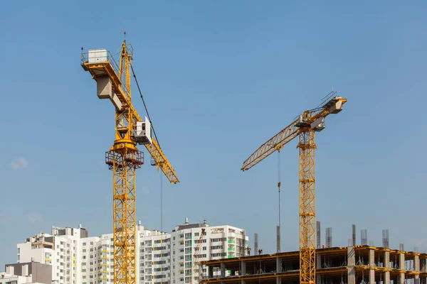 construction site with cranes against the blue sky