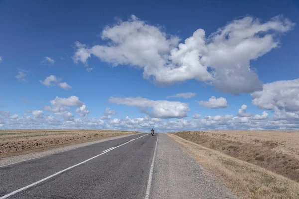 Country road against the blue sky in summer