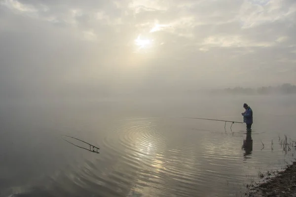 Man Stands Water Catches Fish Morning Mist — Stock Photo, Image