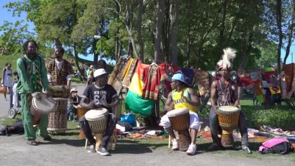 I giovani dell'Africa e la gente del posto ballano e suonano la batteria tradizionale in un parco cittadino a Helsinki . — Video Stock