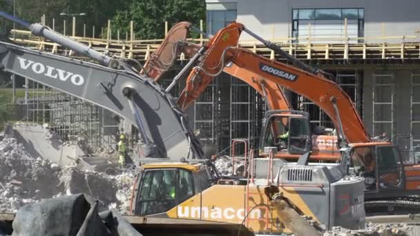 Heavy construction machinery working on the construction of a new residential area. — Stock Video