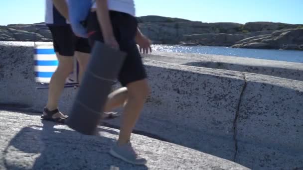 Mensen lopen onder de kust stenen in Tjome Natuur Park, Noorwegen — Stockvideo