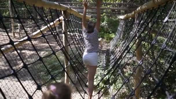 Los niños en el parque de cuerdas pasan obstáculos . — Vídeo de stock