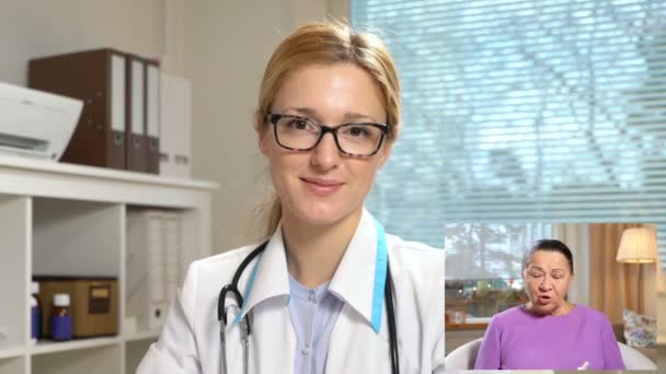 Medicine online. Elderly woman consulting with her doctor using video chat at home — Stock Video