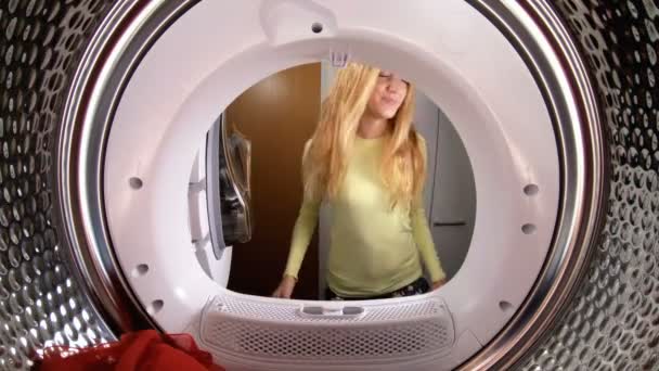 Funny little girl her mother and father loading the clothes to washing machine. — Stock Video