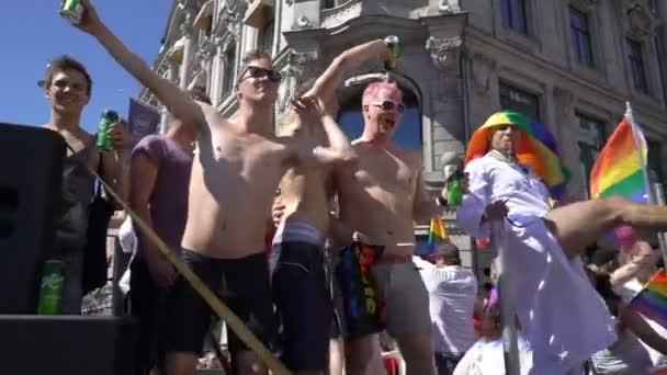 The Pride Parade in Oslo Norway. Young people sing and dance standing on a moving platform — Stock Video