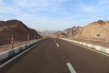 Mavi gökyüzü ve güzel dağ manzarası olan yol