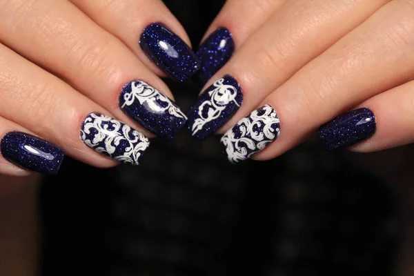 Beautiful woman\'s nails with beautiful christmas manicure studio