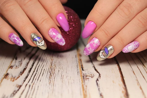 Beautiful woman\'s nails with beautiful christmas manicure studio