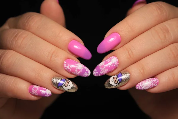 Beautiful woman\'s nails with beautiful christmas manicure studio