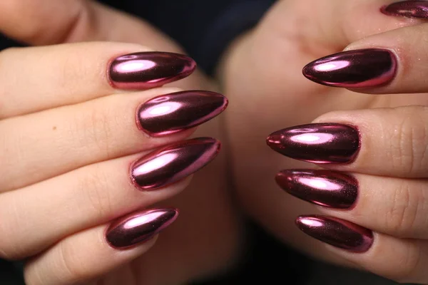 Gorgeous manicure, dark purple tender color nail polish, closeup photo.