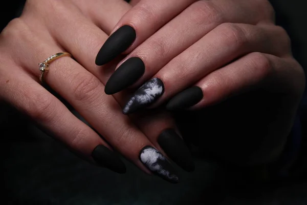 Closeup of hands of a young woman manicure on nails against white background — 스톡 사진