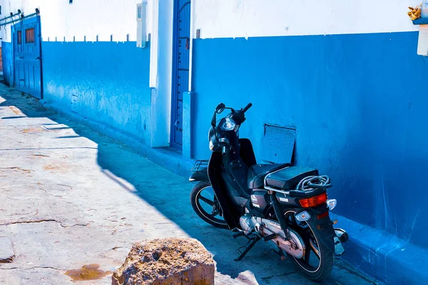 Motorbike, scooter standing in a narrow historic street - Rabat