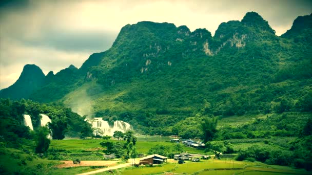 View of valley with green rice terraces and village. Sapa, Vietnam, June 2015. 4K resolution retro look. — Stock Video