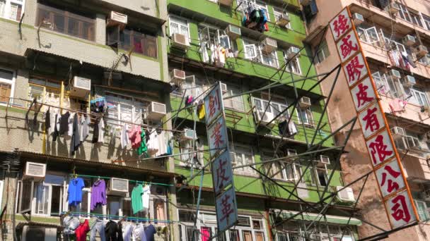 Hong Kong street view. Colourful houses with hanging laundry and signboards. Kowloon  October 2015 — Stock Video