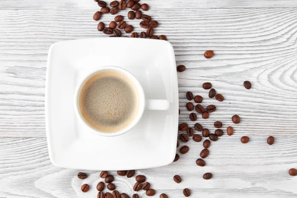 kahve kahve fasulye üzerinde beyaz ahşap arka plan, üstten görünüm