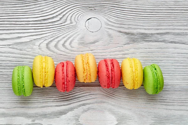 renkli macarons ahşap masa üzerinde. üstten görünüm