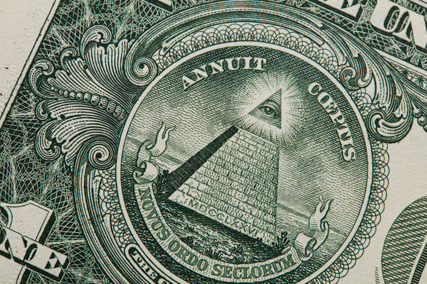 Close up of the pyramid and eye on the back of a one dollar bill