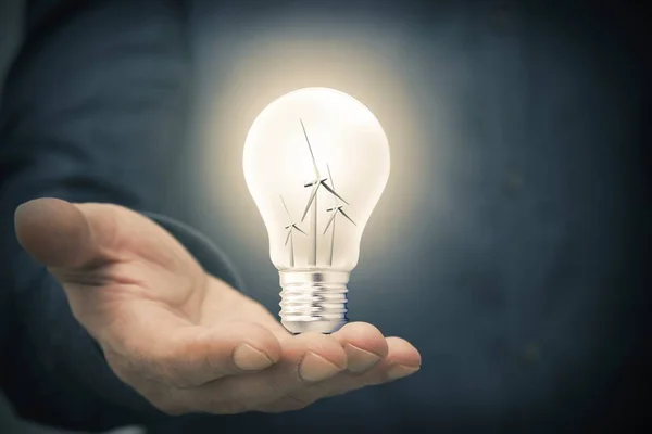 Hand Med Lampa Och Väderkvarnar Begreppet Förnybar Energi — Stockfoto