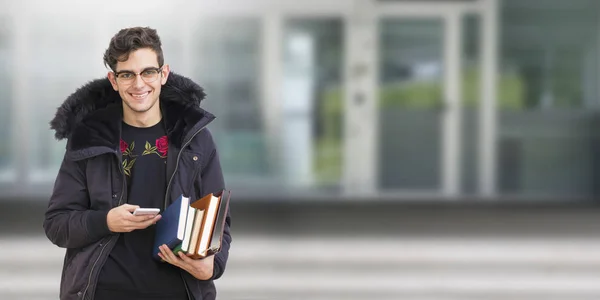 Молодий Студент Мобільним Телефоном Книгами — стокове фото