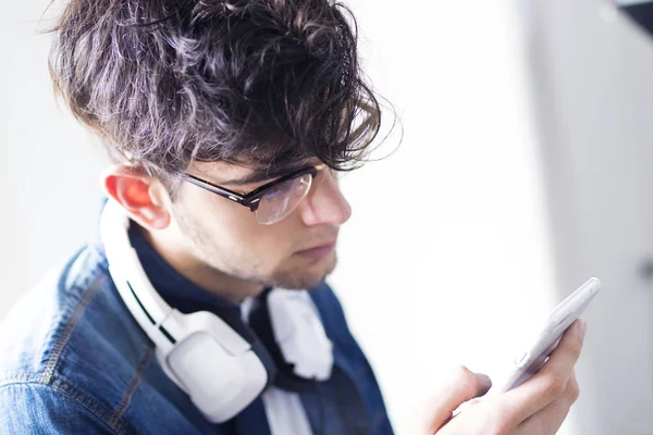 young man with earphones and mobile phone